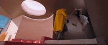 a man in a yellow coat stands next to a woman