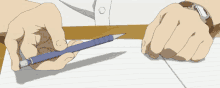 a person wearing a watch is holding a pen over a piece of paper