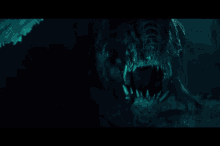 a close up of a person 's face in the dark with a blue light coming out of it .