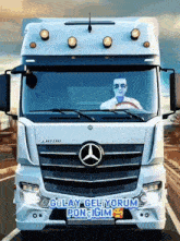 a man is driving a mercedes truck with gulay geliyorum written on the front