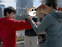 a group of young men are standing next to each other and fighting each other .