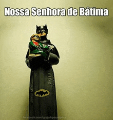 a statue of nossa senhora de batima holding a baby