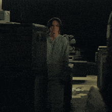 a man in a scrub is standing in front of a cabinet that says ' a ' on the front