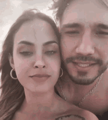 a man and a woman are posing for a picture