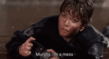 a man laying on the ground with the words murphy i 'm a mess written below him
