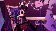 a cartoon character is sitting at a table with a card with a heart on it