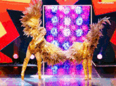 two women in gold feathered costumes are dancing on a stage with t4yce tumblr in the lower right corner