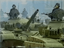 a group of military tanks are parked in a line