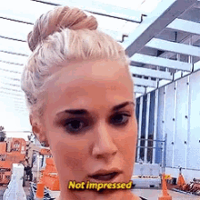 a woman is making a funny face and says not impressed