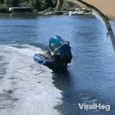 a video of a person riding a jet ski on a body of water with the words viralhog on the bottom right