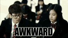 a boy and a girl are looking at each other in a classroom with the word awkward written above them