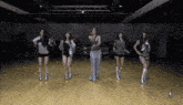 a group of women are dancing together in a room