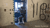a boston dynamics robot is standing in a room