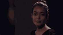 a close up of a woman 's face in a dark room .