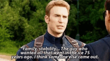 a man in a captain america uniform is talking to another man in a suit .