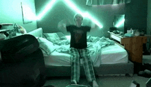 a man is sitting on a bed with his arms outstretched and a green light coming out of his head .