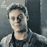 a close up of a man 's face with the hashtag tiktok
