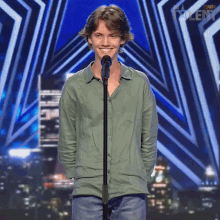 a young man is standing in front of a microphone with the word talent on the bottom