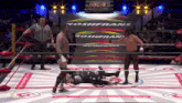 two wrestlers in a ring with the word roshfrans on the wall behind them