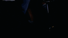 a blurry picture of a woman riding an exercise bike with the word elliptical on her shirt