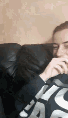 a man is sitting on a couch wearing a nike shirt