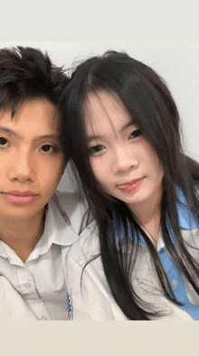 a boy and a girl are posing for a picture and the girl is wearing a shirt that says ' a ' on it