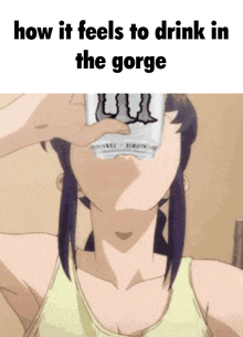 a woman is drinking a monster energy drink from a cup