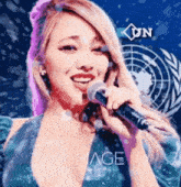 a woman is singing into a microphone with the word vimage in the background