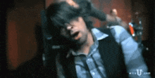 a blurry picture of a man with mtv.com written on the bottom