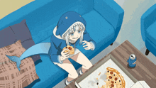 a girl in a shark costume is sitting on a couch eating a pizza