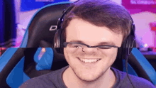 a man wearing glasses and headphones with the letter d on his chair