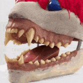 a model of a clown 's teeth and mouth with a red feather on top