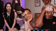 a group of people are sitting in a room with a sign that says world beyonce day .