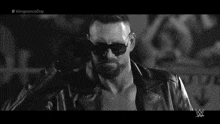 a black and white photo of a man wearing sunglasses and a leather jacket with #vengeanceday written on the bottom