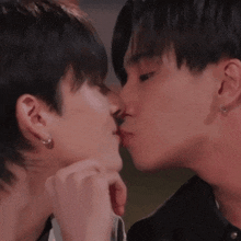 two young men are kissing each other on the cheek