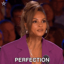 a woman wearing a purple jacket and earrings says perfection