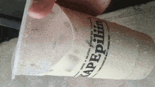 a person is holding a cup of kapepilim coffee milk tea and fruit tea