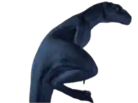a blue dinosaur with yellow eyes is sitting on a white surface
