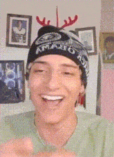 a man wearing a beanie that says athletic on it is smiling