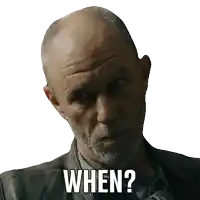 a bald man with a beard is asking the question when