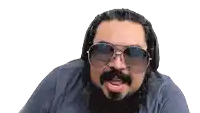 a man with a beard wearing sunglasses and headphones makes a funny face