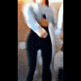 a blurry picture of a woman standing in a room
