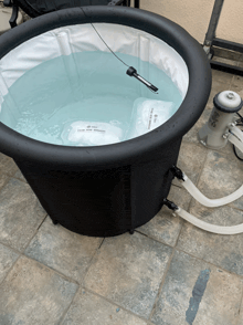 a black tub filled with blue water and a filter