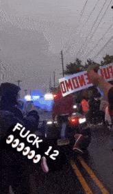 a person holding up a sign that says omowe