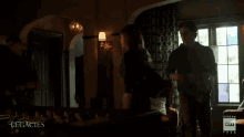 a man and a woman are standing in a room with the words legacies on the bottom