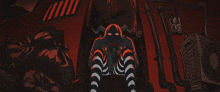 a drawing of a demon with horns and striped pants