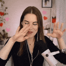 a woman wearing headphones and a microphone covering her nose
