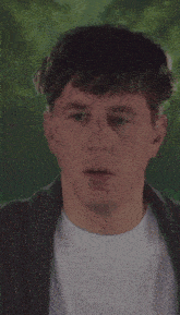 a close up of a man 's face with a white shirt and a gray jacket