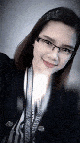 a woman wearing glasses and a lanyard that says ' guinness world records ' on it