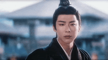 a man in a traditional costume with a bun on his head .